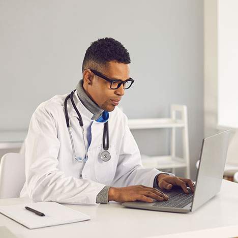 A doctor reviews a car accident victim’s medical records for attorney.