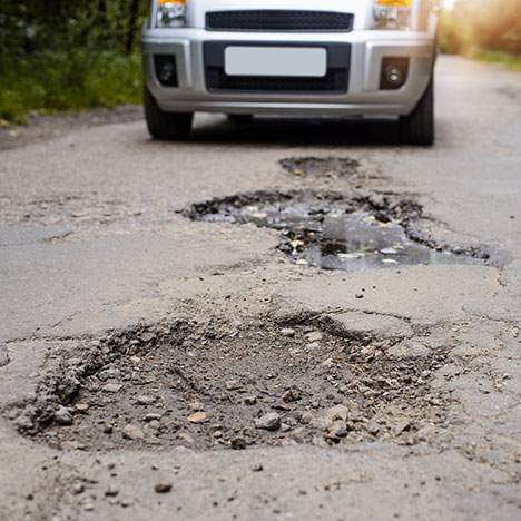 When roads in poor condition cause a car accident, file a lawsuit against the agency responsible for the road’s care.