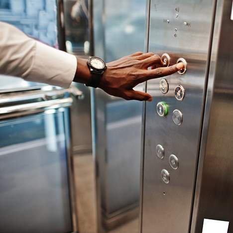 Hand pressing an elevator button - learn about the average settlement for elevator accident injuries