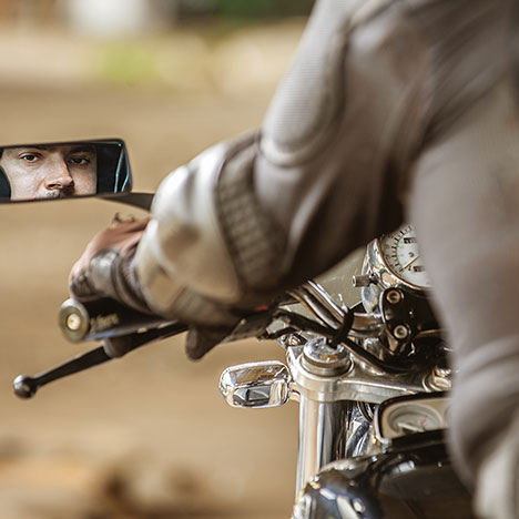 Motorcyclist checks his mirror before entering a California roadway.