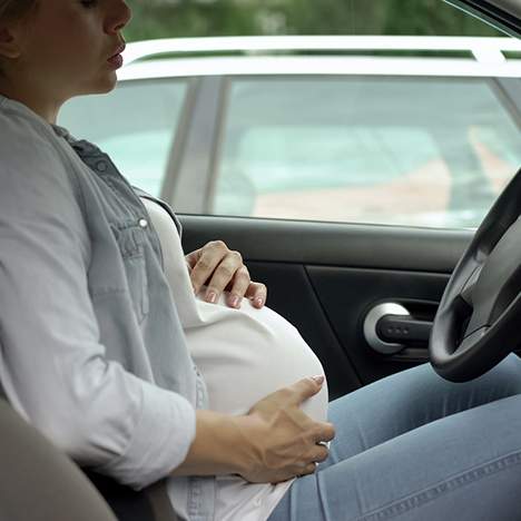 Pregnant driver holding her stomach - find out what to do after a car accident while pregnant