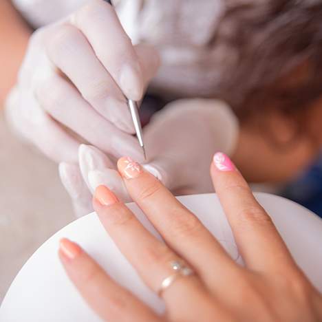 Woman getting her nails done at a salon - learn how to pursue a nail salon infection lawsuit