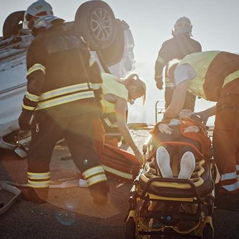 First responders helping in the aftermath of an SUV rollover risk accident