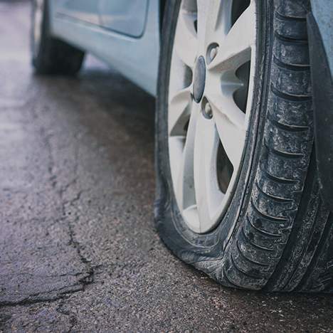 Flat tire on cracked road - is damage from a tire blowout covered by insurance?
