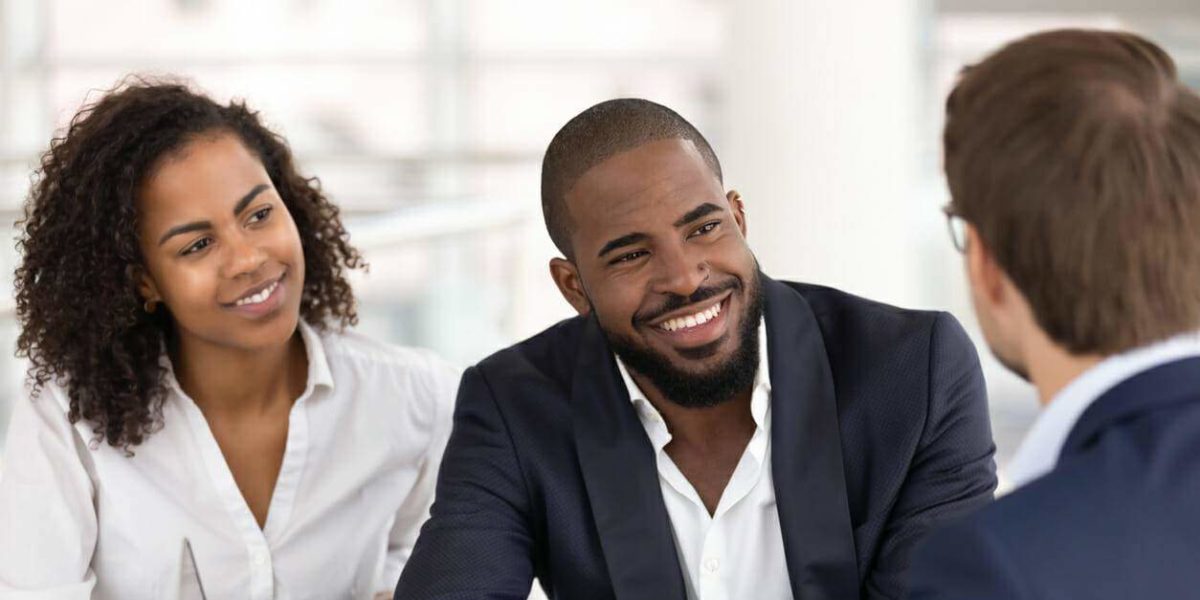 A personal injury attorney meets with potential clients in an office