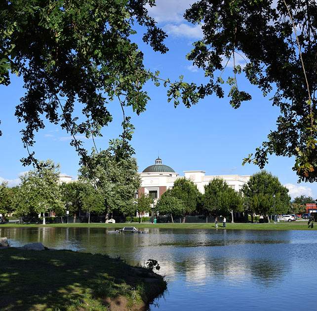 Shaded lake view of ornate building - an area served by Bakersfield law firm Avrek Law