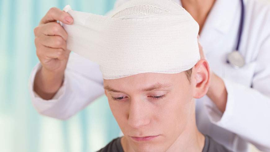 Man is bandaged after suffering a head injury in a traumatic auto accident.