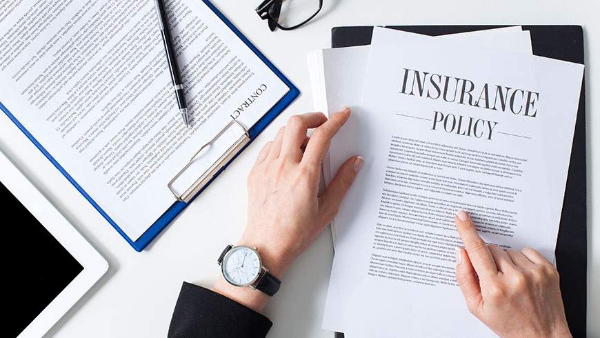 A woman closely examines her insurance policy after an auto accident