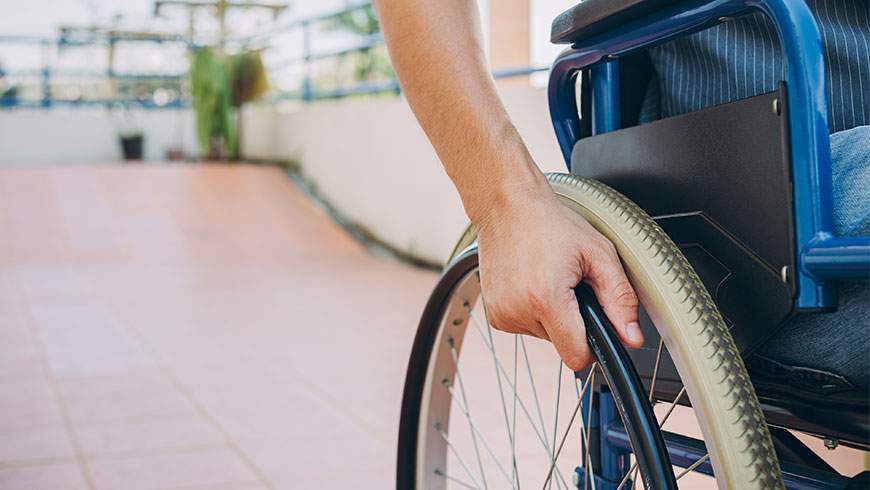 A man sits in a wheelchair after suffering quadriplegic injury in a car accident