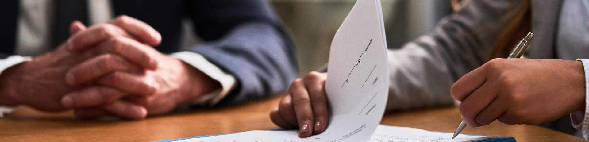 Two people going over paperwork at an office desk