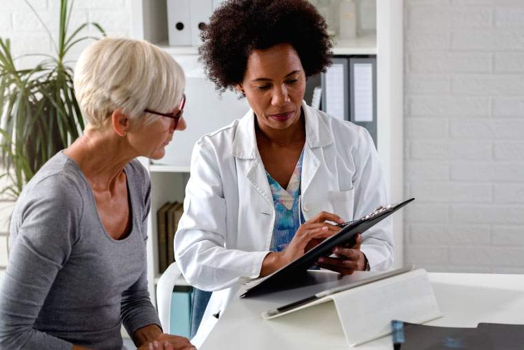 A doctor reading test results to a patient