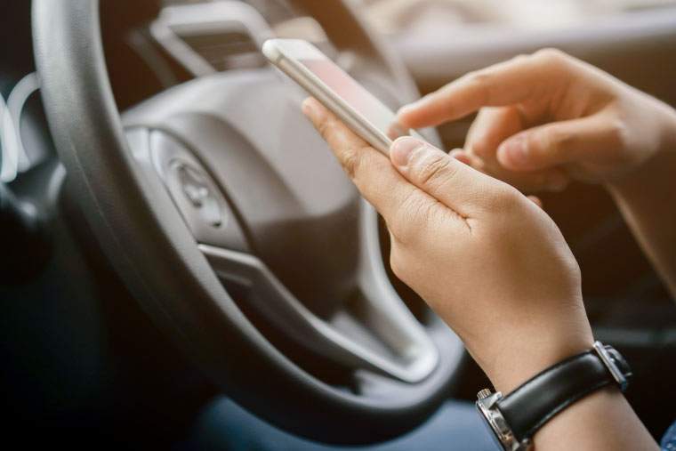 A person texting while driving