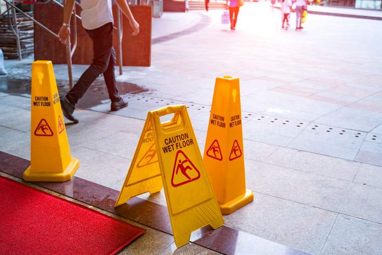 Various warning signs that read caution, wet floor