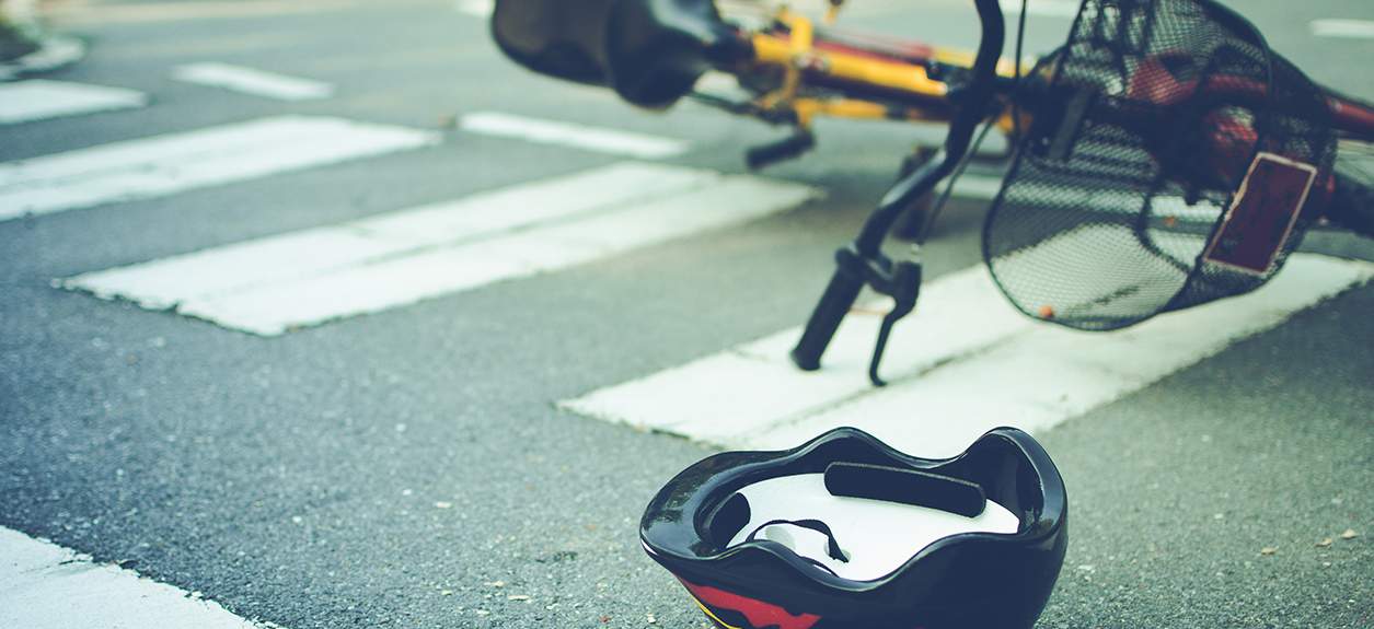 Bicycle and helmet in crosswalk, illustrating potential dangers of cycling in San Francisco