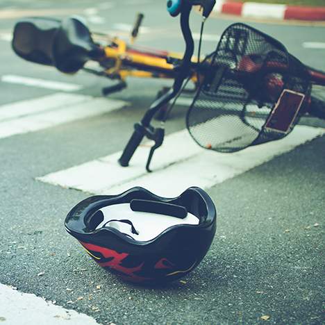 Bicycle and helmet in crosswalk, illustrating potential dangers of cycling in San Francisco