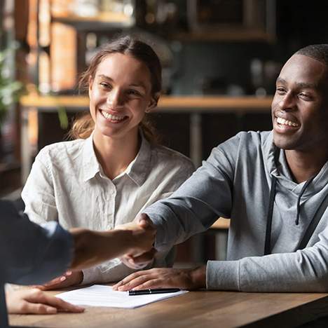 Couple shaking hands with a legal professional, possibly having no win no fee explained