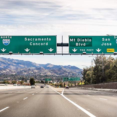 Open freeway with signs to Sacramento - learn about Sacramento traffic accidents and Vision Zero