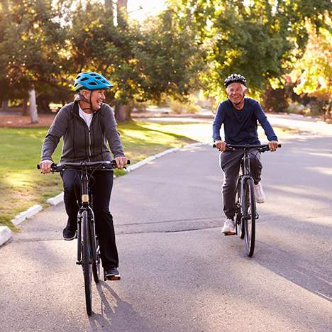 Elderly couple riding bikes in a parkway, likely abiding by applicable Los Angeles bicycle laws
