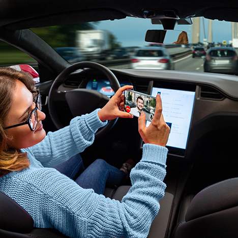 Driver watching her phone in autonomous car - who is responsible for self-driving car accidents?