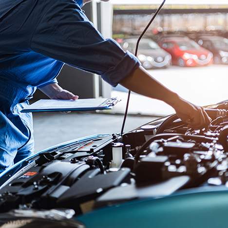 Mechanic's arm reaching into car hood - find an auto repair negligence attorney near me