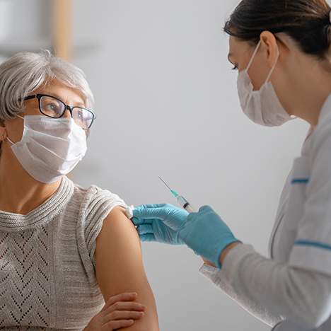 Older woman in mask about to get a shot - is it possible to win a COVID vaccine lawsuit?