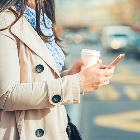 Woman watching phone while crossing street - what are the main causes of pedestrian accidents?