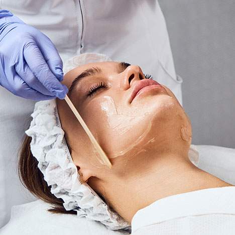 Woman at salon undergoing facial skin treatment - can you sue a salon for chemical burns?