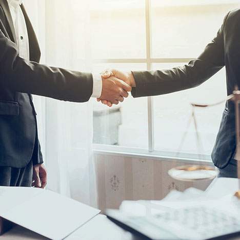 Detail of two attorneys shaking hands - who was the first female lawyer?