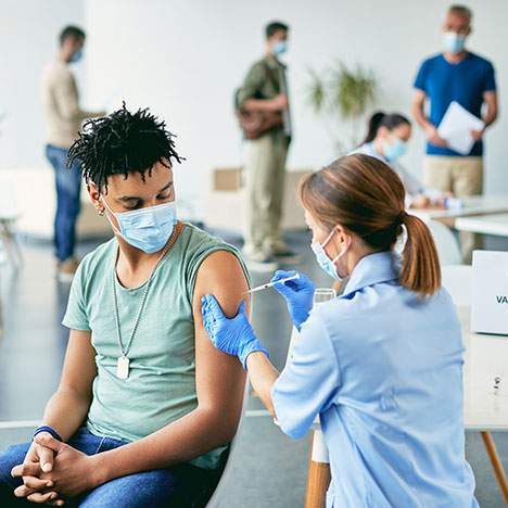 Masked man getting vaccinated - can you pursue a COVID vaccine mandate lawsuit in 2022?