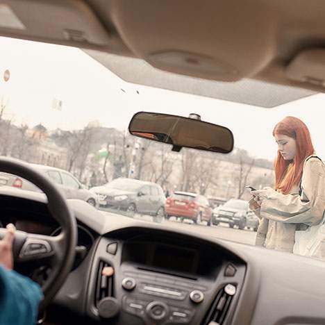 Woman looking at her phone crossing the street - what happens if a pedestrian caused an accident?