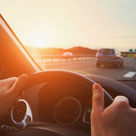 View of blurry road with hands on wheel - learn how to prove speeding in a car accident