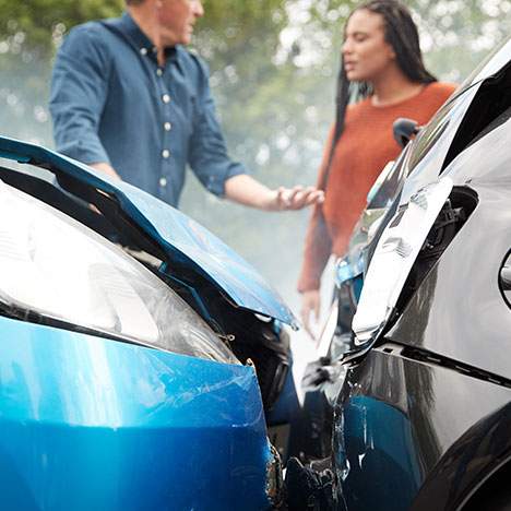 A man and a woman arguing in front of a crash - learn how to win a he said she said car accident