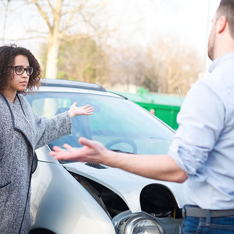 Two people arguing next to a car accident - should you move your car after an accident?