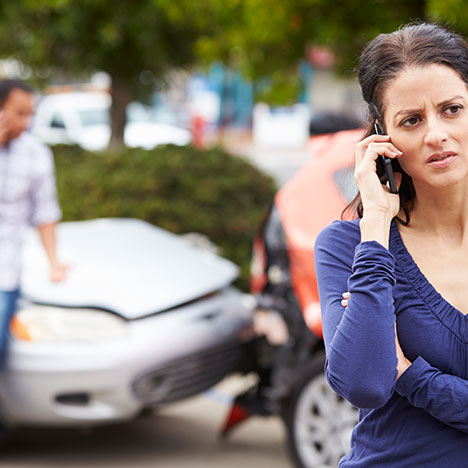 Woman on a phone call after a crash, potentially contacting a lawyer for a Pittsburgh car accident