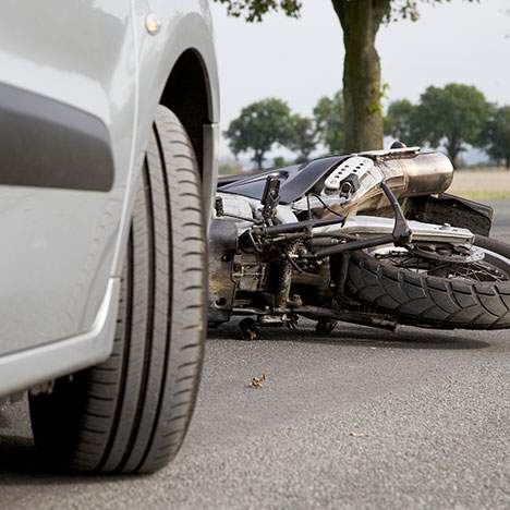Tire next to motorcycle on ground - how often do motorcycles crash?