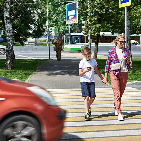 incoming car as mother and child walk across the street - find a pedestrian injury accident law firm