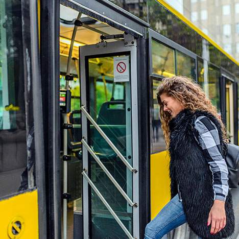Woman getting on the bus - how many bus accidents per year?