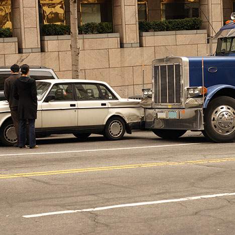 blue truck hit a white car, two people outside care - What to Do if You Are in a Bus Accident