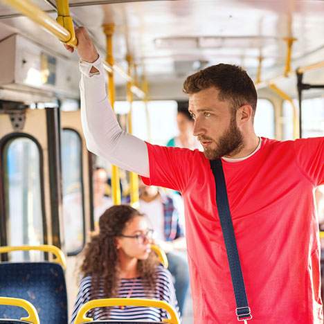 man with a red shirt inside a bus thinking What to Do After a Riverside Bus Accident