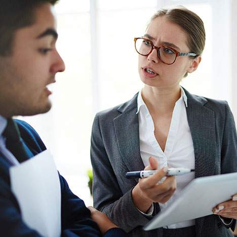 man and woman speaking both wearing suits - Orange County car accident Lawyer