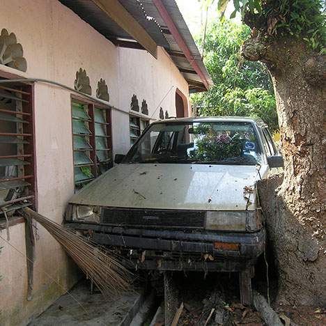 car wedges between a house and tree - what happens if a car crashes into your house