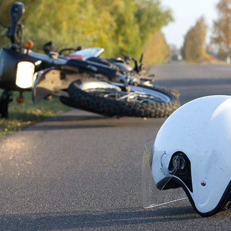 fallen motorcycle and helmet - motorcycle accident compensation payouts