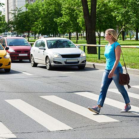 pedestrian walking on a cross walk